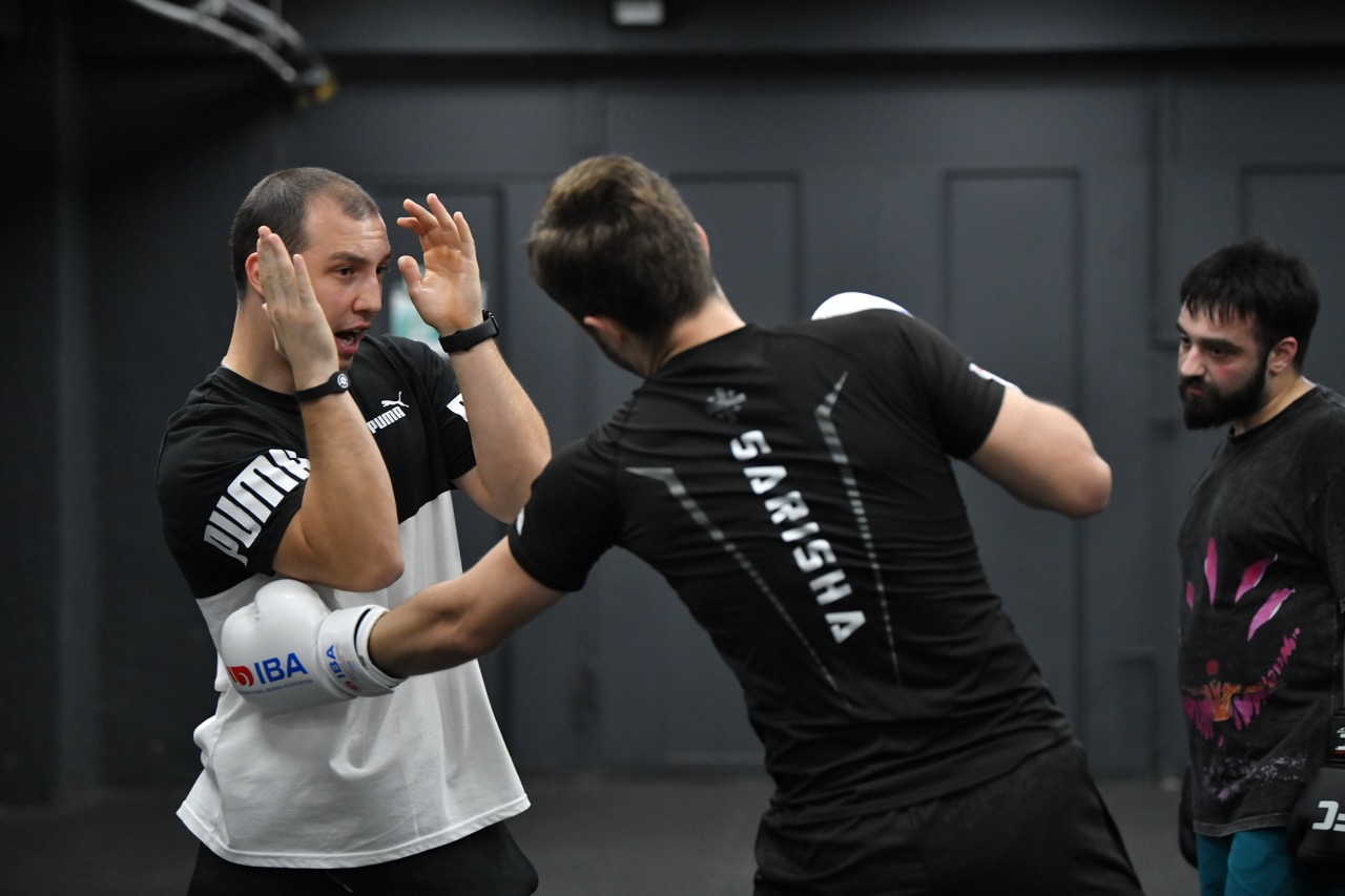 Kickboxing pad work on the training mats